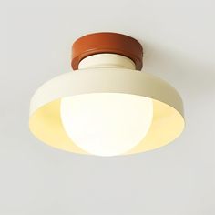 a white and brown light hanging from the ceiling