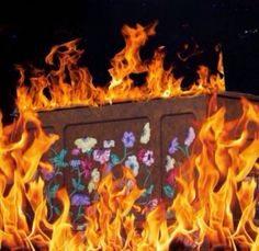 a box on fire with flowers painted on it