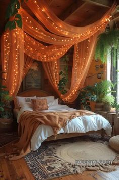 a bed covered in orange drapes and lights