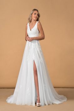 a woman wearing a white wedding dress with a slit