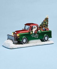 a green and red truck with a christmas tree on the back