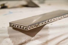 Adding some upholstery tacks covers the staples and adds some more bling Diy Bathroom Wall, Diy Glam Decor, Bathroom Wall Shelf, Mermaid Bathroom Decor, Sewing Room Storage, Metal Wall Shelves, Upholstery Tacks, Bathroom Wall Shelves, Shelving Ideas