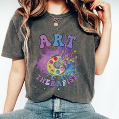 The comfortable fit and cool design of this art therapist shirt means that it feels just as good to wear as it is to look at. If you've been looking for a fun t-shirt for yourself, or your favorite art therapy friend, you should get this cute tee today.   This Comfort Colors t-shirt is made with 100% with ring-spun cotton. The soft-washed, garment-dyed fabric brings extra coziness to your wardrobe while the relaxed fit makes it an excellent daily choice. The double-needle stitching throughout the tee makes it highly durable while the lack of side-seams helps the shirt retain its tubular shape. .: 100% ring-spun cotton .: Medium fabric  .: Relaxed fit .: Sewn-in twill label   ✈ PROCESSING & SHIPPING ✈  Processing Time: 1-2 weeks   (usually 1-3 days) Standard Shipping: 2-5 business days afte Therapy Friend, Jennifer Ward, Therapy Art, Art Therapist, Therapy Gift, T Shirt Art, Shirt Art, Gift Art, Star Shirt