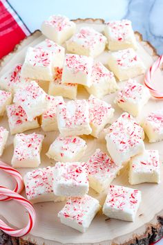 peppermint marshmallows and candy canes on a wood slice