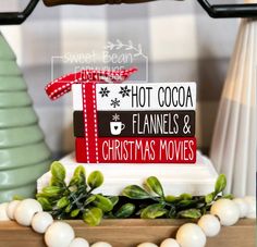 there is a sign that says hot cocoa, flannels and christmas movies on it