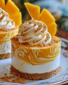 two desserts on a plate topped with whipped cream and orange zest toppings