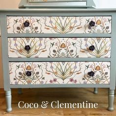 an ornate painted dresser with flowers and leaves on the drawers is featured in this article