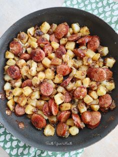 a skillet filled with potatoes and sausage