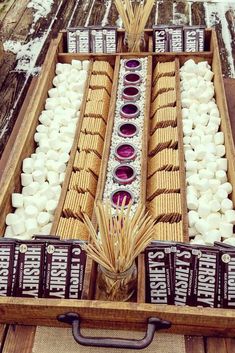 a wooden box filled with marshmallows on top of a table