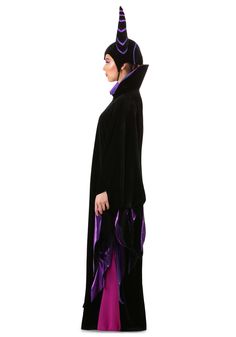 a woman in a black and purple costume is standing with her hands on her hips