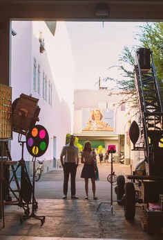 two people standing in front of a camera set