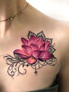 a woman's chest with a pink flower tattoo on her left arm and shoulder