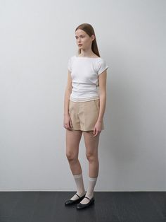 This product is a contemporary reimagining of the classic shorts, offering a sleek and minimalistic design. The garment is characterized by its clean lines and a subtle side zipper closure which ensures a smooth, uninterrupted silhouette. Designed for versatility, these shorts serve as an essential wardrobe staple that pairs seamlessly with varied styles, from casual to smart-casual. - The tailored fit provides a sophisticated edge to a casual staple.- Constructed with a lightweight fabric for all-day comfort and ease of movement.- Side zipper closure offers a streamlined look and a secure fit.- Neutral tone makes it a perfect base for multiple outfit combinations. Modern Fitted Shorts, Fitted Cotton Modern Shorts, Modern Fitted Shorts For Spring, Modern Short Leg Shorts For Spring, Modern Spring Shorts With Short Legs, Modern Summer Shorts, Spring Modern Short Leg Shorts, Modern Relaxed Fit Shorts, Classic Shorts