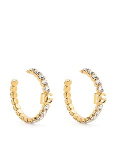 Listening crystals adorn these hoop earrings from Dolce & Gabbana, that feature the house's iconic DG plaque at the front and an open design. They're finished with refined gold-tone hardware and a push-back stopper.Made in ItalyHighlightsgold-tonecrystal embellishmentsignature DG logo plaquelarge hoop designpush-lock fasteningThese earrings come as a pair.CompositionBrass, GlassBrand style ID: WEN6L2W1111Col: ZOO00 Dolce Gabbana Earrings, Dolce And Gabbana Jewelry, Extravagant Earrings, Dolce Gabbana Jewelry, Dolce And Gabbana Earrings, Dg Logo, Hoop Design, Golden Earrings, Expensive Jewelry