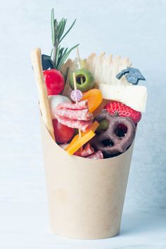 a paper cup filled with different types of food