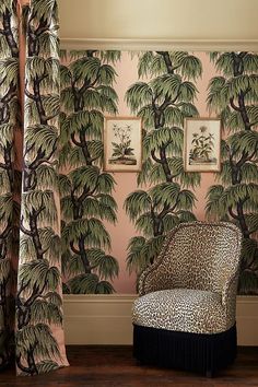 a leopard print chair in front of a wall with palm trees on it and curtains