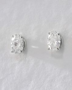 Our Ultimate Diamond Stud Earrings are a modern-take on the classic and timeless solitaire diamond studs. These stunning earrings feature an oval-cut brilliant diamond with modern prong settings that are perfect for everyday wear. With a high shine finish and comfortable fit, they're the ideal choice for any lobe piercing. Available in 0.5ct and 1ct sizes for a luxe look. Elegant Gia Certified Oval Diamond Earrings, Classic White Oval Diamond Earrings, Modern Oval Brilliant Cut Earrings, Classic Oval Diamond White Earrings, Classic Oval Diamond White Diamond Earrings, Timeless Oval Brilliant Cut Earrings, Gia Certified Oval White Gold Diamond Earrings, Oval Diamond Earrings With Vvs Clarity, Classic Oval Diamond Cut Earrings