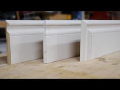 three white doors sitting on top of a wooden table