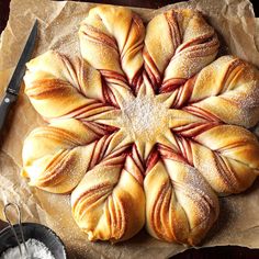 a pastry is shown with powdered sugar in the shape of a snowflake