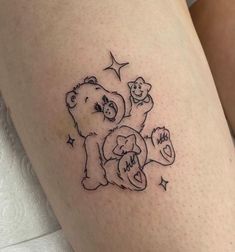 a small tattoo on the leg of a woman's thigh, depicting two bears