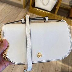 Tory Burch Emerson Top Handle Women's Saffiano Leather Crossbody Bag ) With Gold Tone Hardware Interior Feature Tory Burch Fabric Lining, 1 Credit Card Slot, And 1 Zip Pocket Non-Adjustable Crossbody Strap Drop 21" To The Top & 25" To The Base Of The Bag Approximate Measurements 8” L X 5” H X 2.25” D Classic White Saffiano Leather Shoulder Bag, White Saffiano Leather Travel Bag, Luxury White Saffiano Leather Shoulder Bag, White Saffiano Leather Bag For Everyday Use, White Saffiano Leather Rectangular Bag, White Saffiano Leather Top Handle Bags, White Saffiano Leather Bag For Daily Use, White Saffiano Leather Bags, White Saffiano Leather Evening Bag