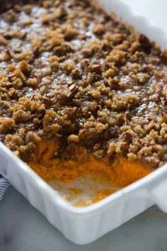 a casserole dish filled with food and topped with crumbs on top