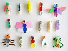 a group of different types of pins and magnets on a white surface with one being made to look like an insect