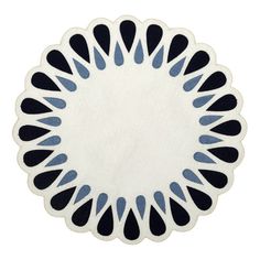 a black and white plate with blue designs on the edges, sitting in front of a white background