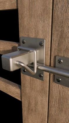 a close up of a metal handle on a wooden door