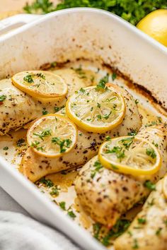 chicken with lemons and herbs in a casserole dish