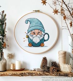 a cross stitch pattern with an image of a gnome in a blue hat on it