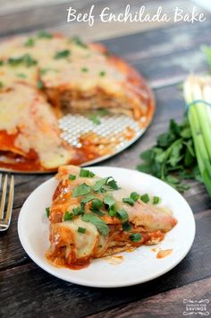 a slice of deep dish enchilada bake on a white plate with green onions