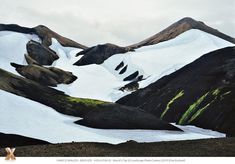 the mountains are covered in snow and have green moss growing on their sides, as if they were melting