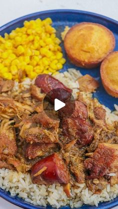 a blue plate topped with rice and meat next to corn