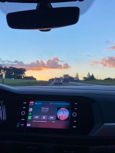 the dashboard of a car with an image of a sunset in the backgroud