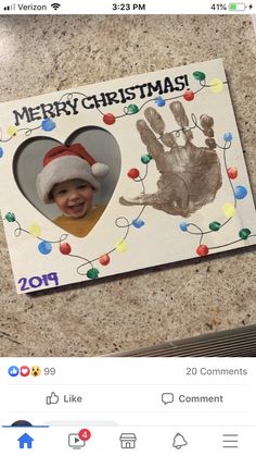 a christmas card with a handprinted heart and a santa's hat on it