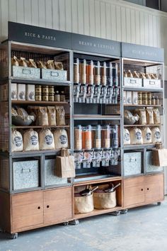 the shelves are filled with many different types of food and drink items in bins