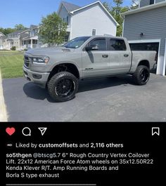 a truck parked in front of a house with black rims on it's tires