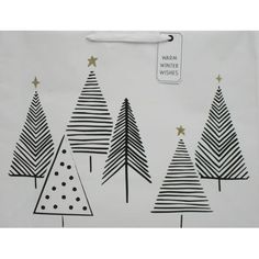 the wrapping paper is decorated with black and white trees, stars and polka dot dots