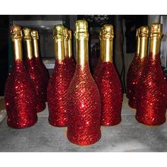 red and gold glittered wine bottles are lined up