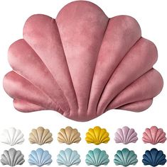 various colors of scallop shell shaped pillow on white background with multiple color options to choose from