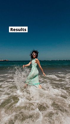 a woman is running through the water at the beach