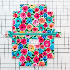 two zippered pouchs with flowers on them, one is blue and the other is pink