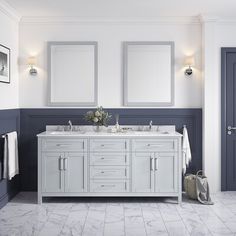 a bathroom with double sinks and two mirrors on the wall next to eachother