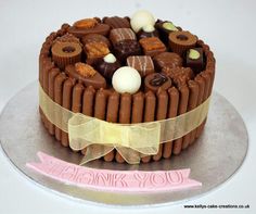 a cake with chocolates and candies on it