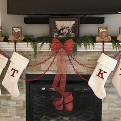 stockings hung over a fireplace with the letters k and t on them