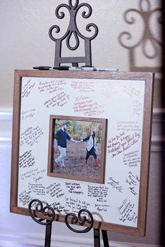 two people holding hands in front of a white board with writing on it and an easel