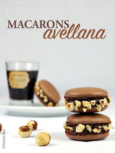 chocolate macarons are stacked on top of each other in front of a cup and saucer