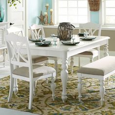 a dining room table and chairs with blue walls in the background, including a rug on the floor