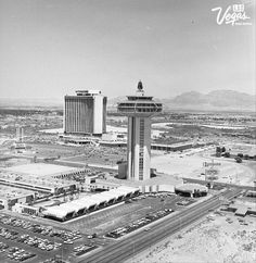 an aerial view of the las vegas strip and surrounding buildings in black and white, with mountains in the background